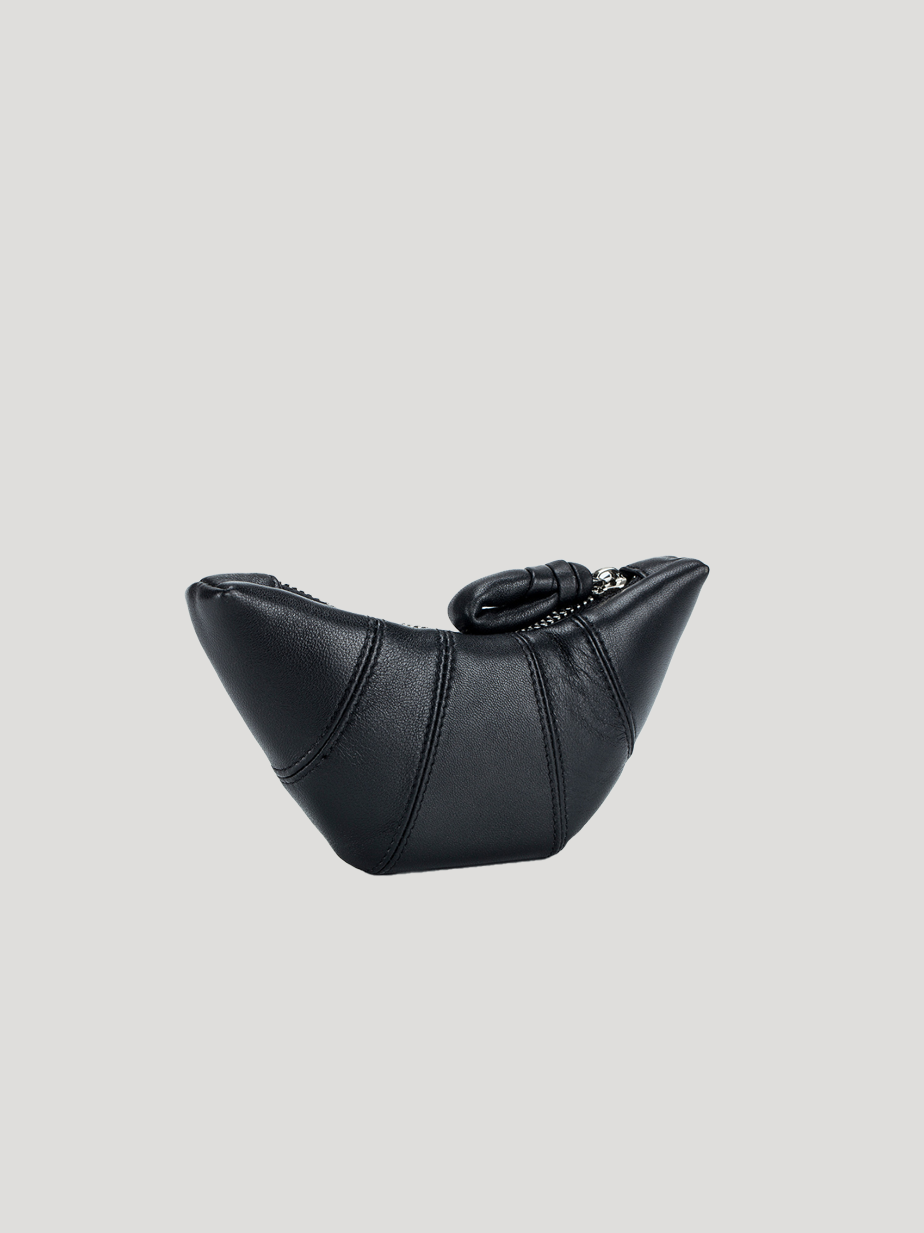 A front view of the croissant-shaped black leather purse, on a white background.