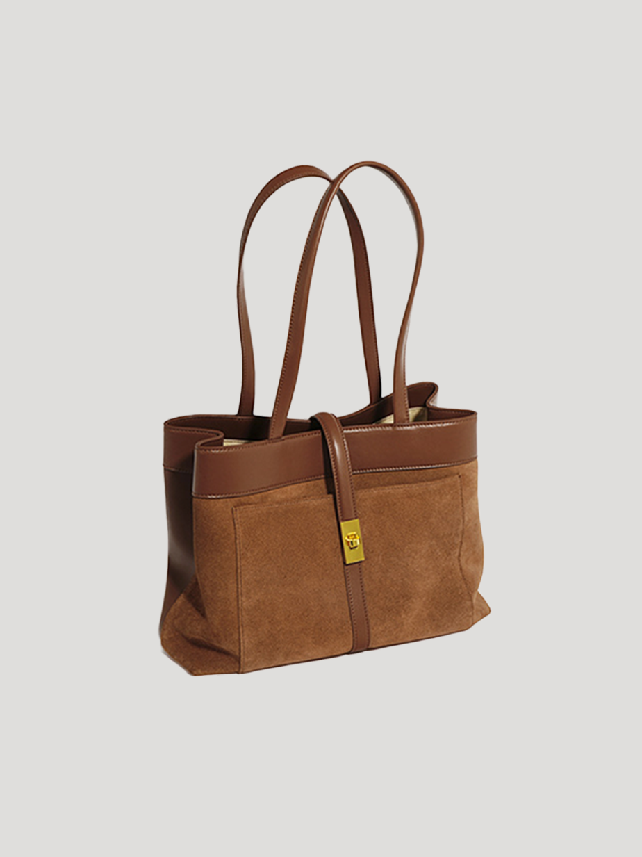 A front-side view of a brown work tote bag with a spacious top-handle design and a golden metal lock, on a white background.