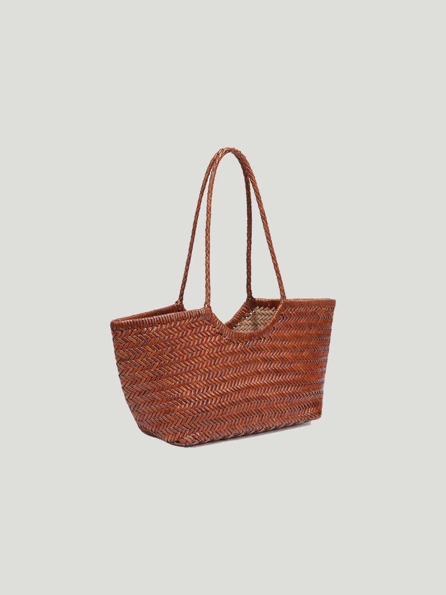 A brown woven leather tote bag with a spacious top-handle design, set against a clean white background, showcasing its stylish and functional features.