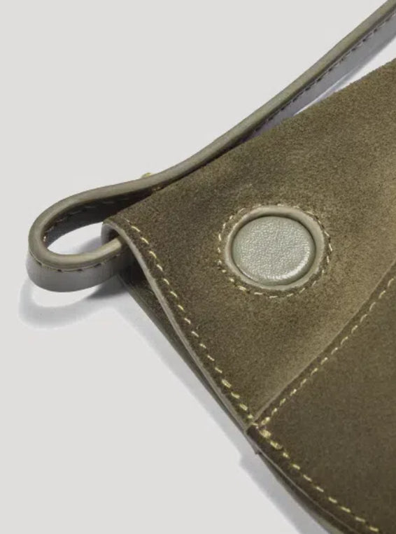 A close-up look at a green leather Polene bag, showcasing its fine leather texture and stitching craftsmanship.